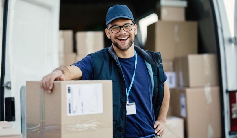 man smiling while making deliveries