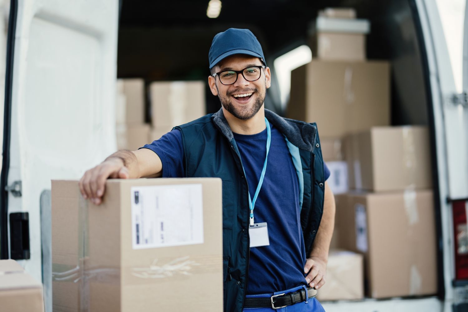 man smiling while making deliveries